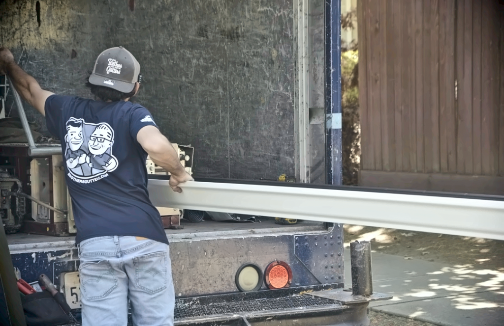 Carrying a formed gutter run from the truck