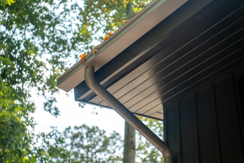 A dark box gutter wrapping a roof corner