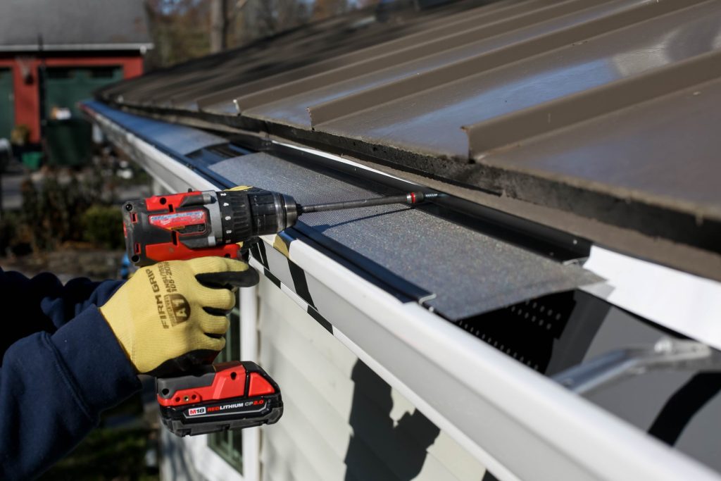 Driving a hanger screw into a new gutter