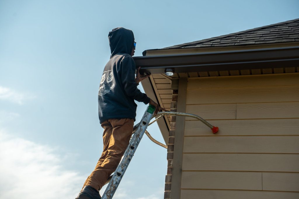 Flushing the gutter and downspout with a hose