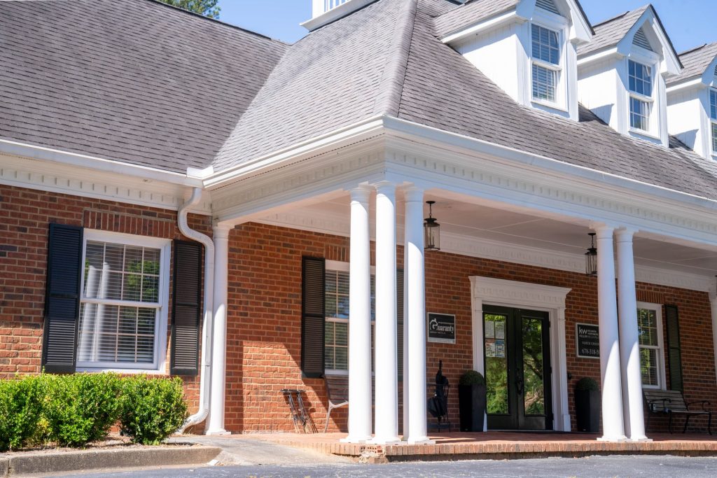 White gutters across a brick building with columns